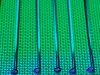 Permukaan wafer silikon berpola dengan kilau hijau dan biru