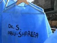 Baju bedah biru bertuliskan nama tenaga kesehatan Palestina digantung di luar sidang WMA di Rotterdam