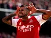Bruno Guimaraes berseragam merah Arsenal merayakan gol dengan kedua tangan di samping kepala