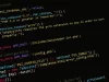 Potongan kode pemrograman PHP berwarna di layar monitor berlatar gelap