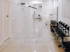 Ilustrasi lorong rumah sakit dengan deret kursi tunggu hitam yang kosong