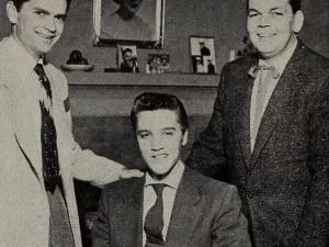 Elvis Presley (tengah) bersama Bob Neal dan Sam Phillips pada 1955