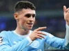 Phil Foden menunjuk ke atas merayakan gol Manchester City di Liga Champions