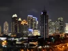Ilustrasi gedung-gedung pencakar langit kawasan niaga SCBD yang menyala pada malam hari di Jakarta