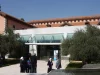 Halaman dalam kampus Damascus University, Suriah, dengan gedung beratap genting merah dan pohon zaitun