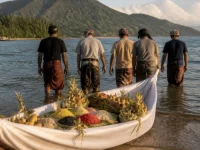 Ilustrasi perahu kecil berbalut kain putih berisi ketupat, ketan, dan buah di tepi pantai