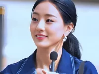 Jihyo TWICE tersenyum memegang mikrofon dalam sebuah acara 2023