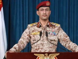 Juru bicara militer Houthi Yahya Saree berseragam loreng berbicara di podium