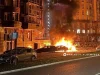 Api berkobar di jalan dekat gedung apartemen dan mobil terparkir usai serangan drone malam hari
