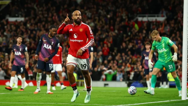 Bryan Mbeumo berseragam merah Manchester United mengacungkan jari merayakan gol ke gawang Tottenham