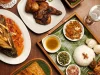 Ilustrasi hidangan Indonesia berupa ikan bersambal, ayam goreng, dan nasi di atas daun pisang