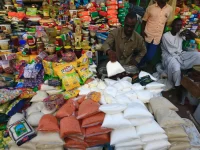 Pedagang menata gula dan barang kebutuhan pokok di kios pasar di Nyala, Darfur Selatan