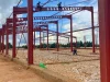 Rangka baja proyek pembangunan pabrik teh di Kyamuhunga, Uganda, dengan beberapa pekerja