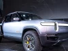 Pendiri dan CEO Rivian RJ Scaringe berdiri di samping truk listrik Rivian R1T