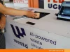 Pengguna memasukkan gelas bekas ke Smart Waste Bin buatan FEB UGM