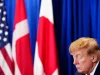 Donald Trump menunduk di depan bendera AS, Denmark, dan Greenland saat penandatanganan