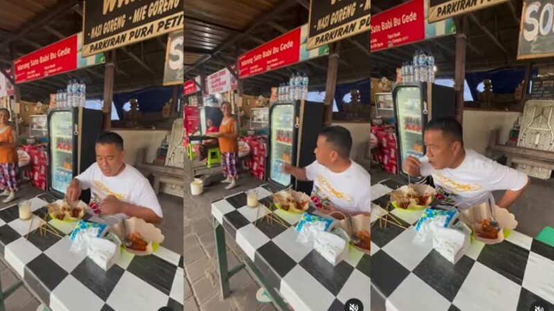Hotman Paris makan sate di pinggir jalan, netizen malah salfok pada tulisan spanduk bermerek sate babi yang ada di belakangnya.